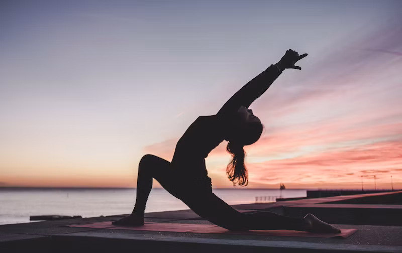Diverse group stretching and doing yoga in a public park